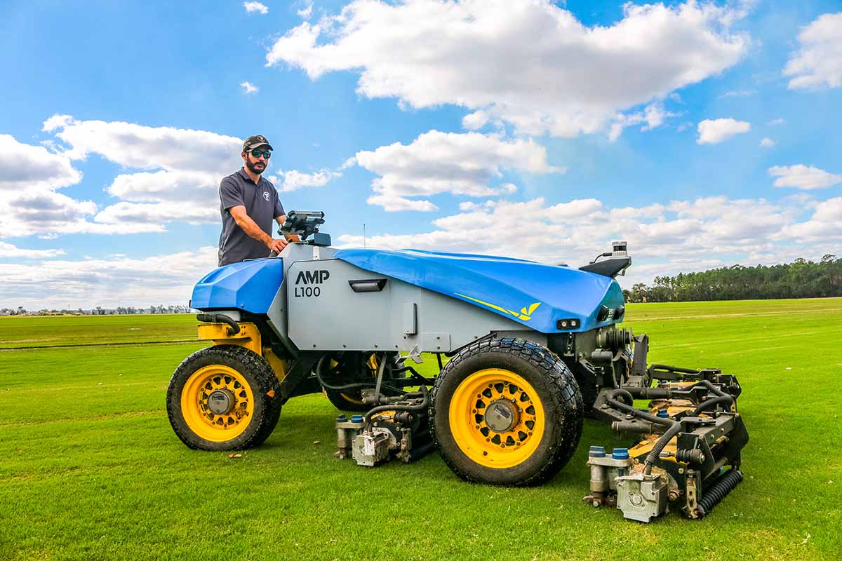 Gage Hjort driving a FireFly AMP mower on a turf farm