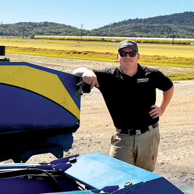 Dylan Reading by FireFly turf harvester in field of grass