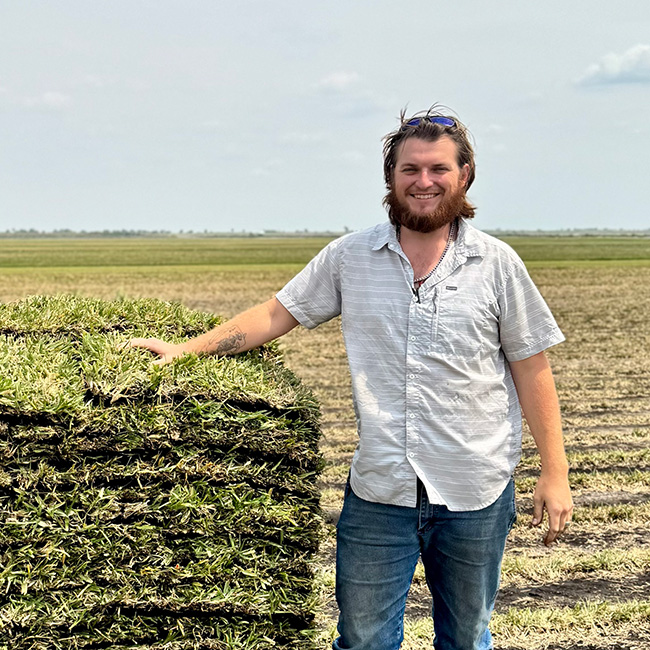 Philip O'Bannon next to a pallet of sod