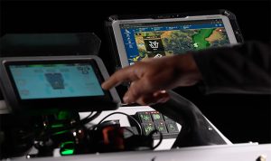 A person's hand touching controls on a AMP mower