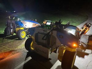 Two FireFly Automatix autonomous mowers in the dark