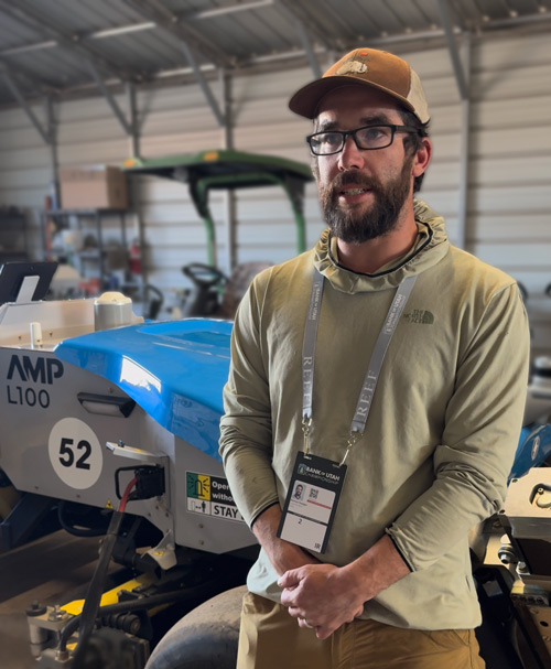 Benton Hodges in front of FireFly autonomous mower
