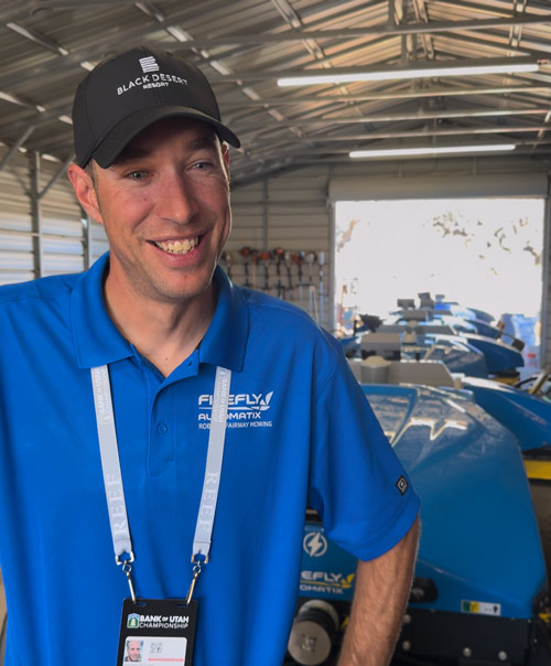 Matt Mutchler in agronomy shed with fleet of FireFly autonomous mowers