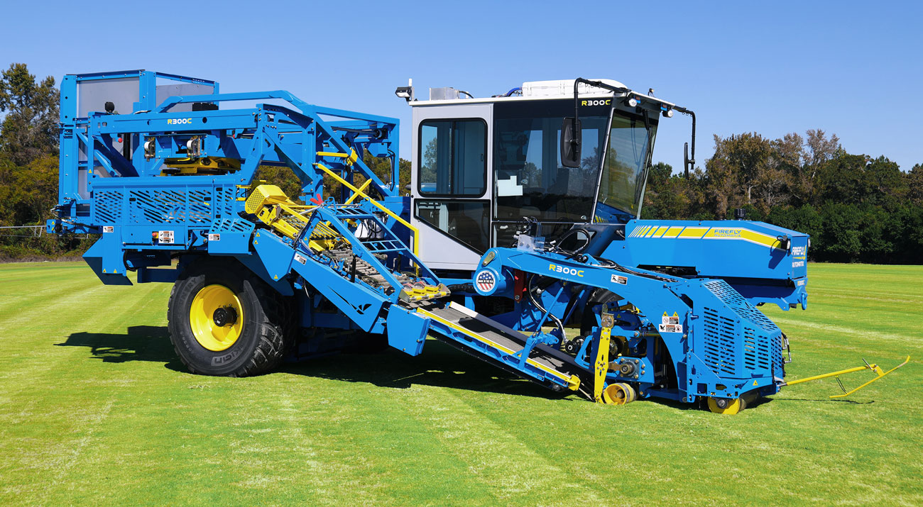 R300C mini-roll precision automated turf harvester on green grass at a sod farm